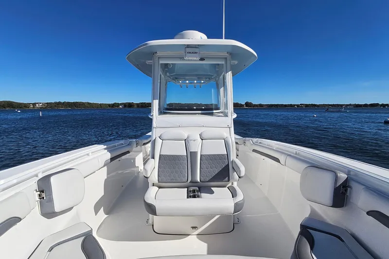 Slide: The Image of 2018 Tidewater 280 CC Adventure boat on calm water under clear blue sky. - 20