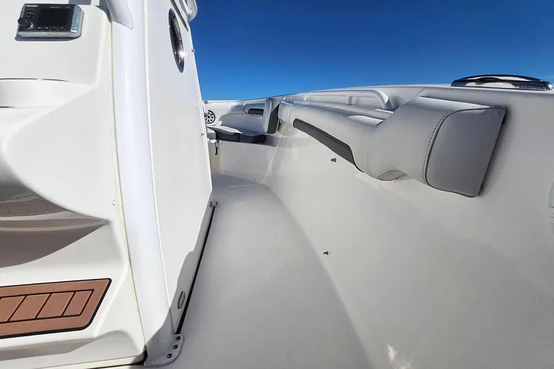 Slide: The Image of 2018 Tidewater 280 CC Adventure boat interior with sleek seating and modern design. - 22