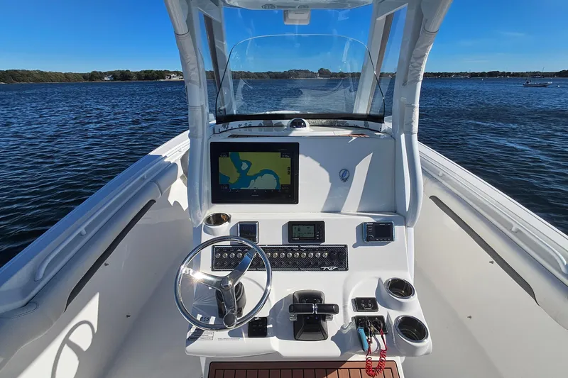 Slide: The Image of 2018 Tidewater 280 CC Adventure boat helm with navigation display on open water. - 26