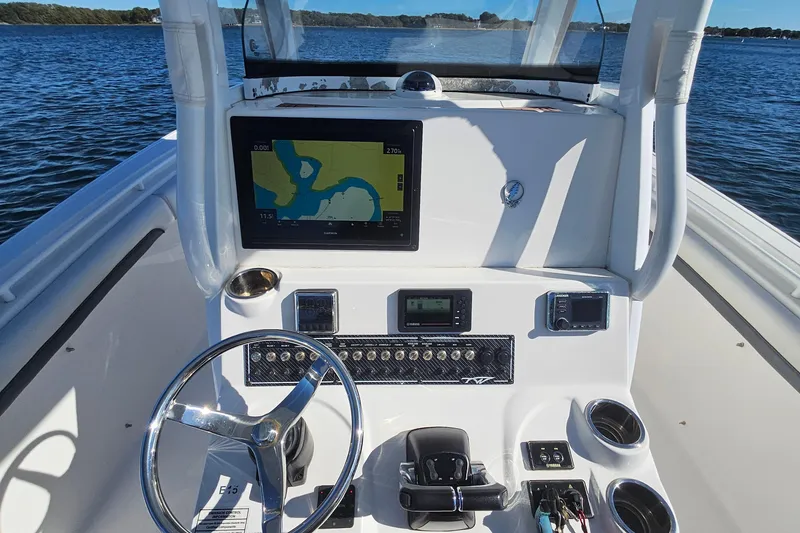 Slide: The Image of 2018 Tidewater 280 CC Adventure boat dashboard with navigation screen and controls. - 27