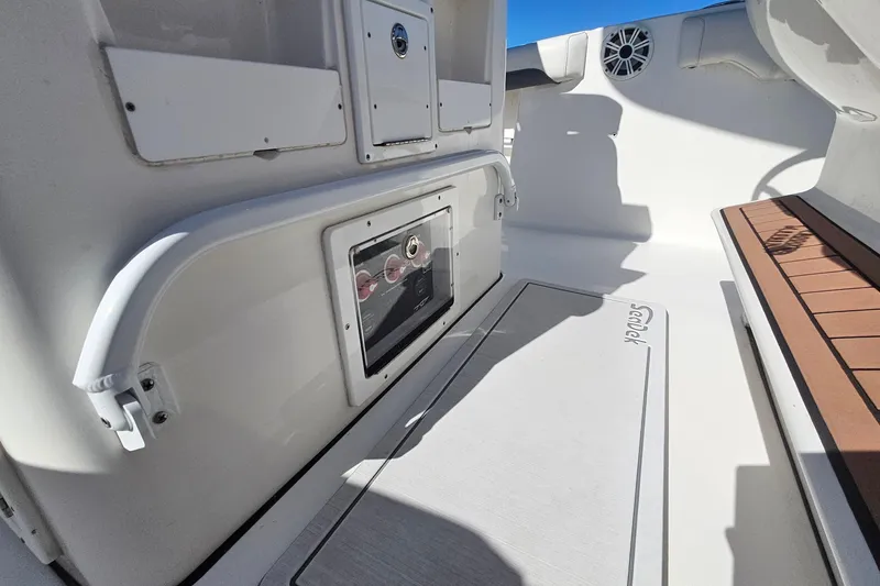 Slide: The Image of 2018 Tidewater 280 CC Adventure boat interior with storage compartments and seating area. - 36