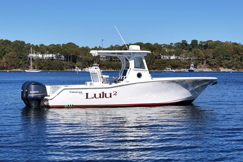 Slide: The Image of 2018 Tidewater 280 CC Adventure boat on calm water, featuring dual Yamaha engines. - 5