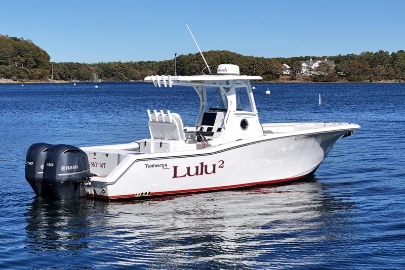 Slide: The Image of 2018 Tidewater 280 CC Adventure boat on calm water with twin Yamaha engines. - 6