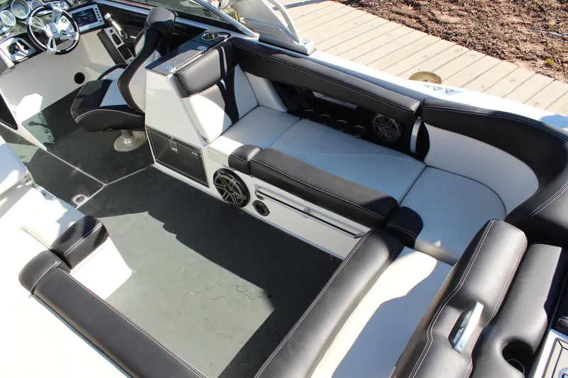 Slide: The Image of 2016 MasterCraft X26 boat interior with black and white seating and modern dashboard. - 11