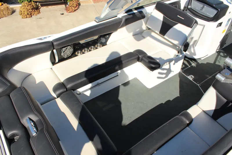 Slide: The Image of 2016 MasterCraft X26 boat interior with black and white seating and audio system. - 12