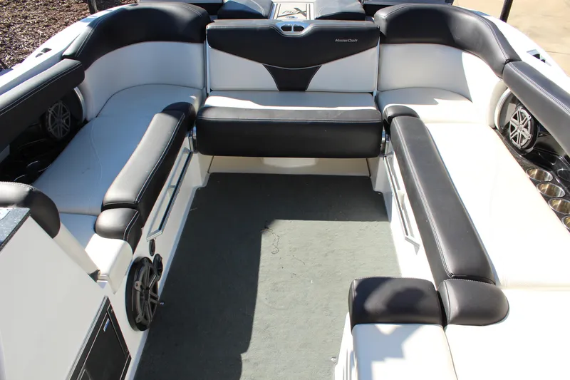 Slide: The Image of 2016 MasterCraft X26 boat interior with black and white seating and speaker system. - 13