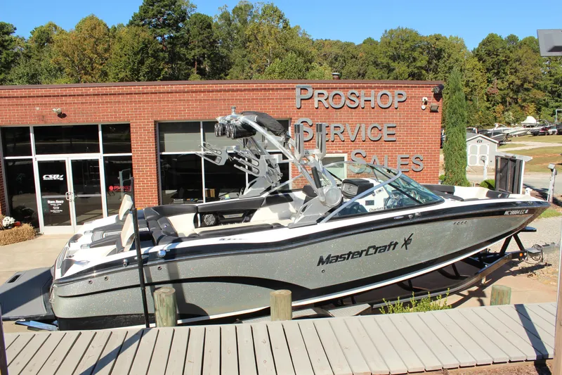 Slide: The Image of 2016 MasterCraft X26 boat displayed outside a pro shop with service and sales signage. - 3
