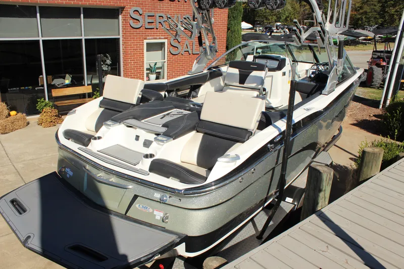 Slide: The Image of 2016 MasterCraft X26 boat displayed at a dealership, showcasing sleek design and luxury features. - 4