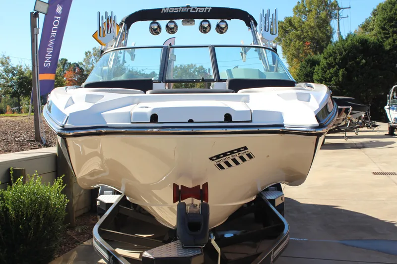 Slide: The Image of 2016 MasterCraft X26 boat displayed outdoors on a trailer. - 9