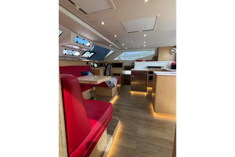 Slide: The Image of Luxurious interior of 2022 Seawind 1600 catamaran with modern kitchen and red seating. - 13