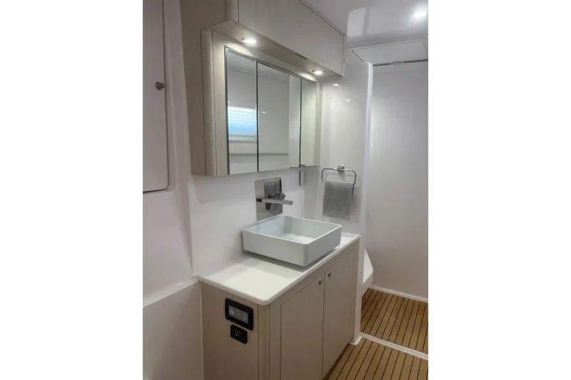 Slide: The Image of Modern bathroom in 2022 Seawind 1600 yacht with sleek fixtures and wooden flooring. - 19