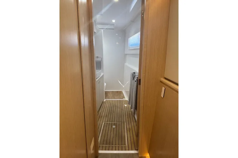Slide: The Image of Interior of 2022 Seawind 1600 yacht, featuring sleek wooden flooring and modern design. - 25