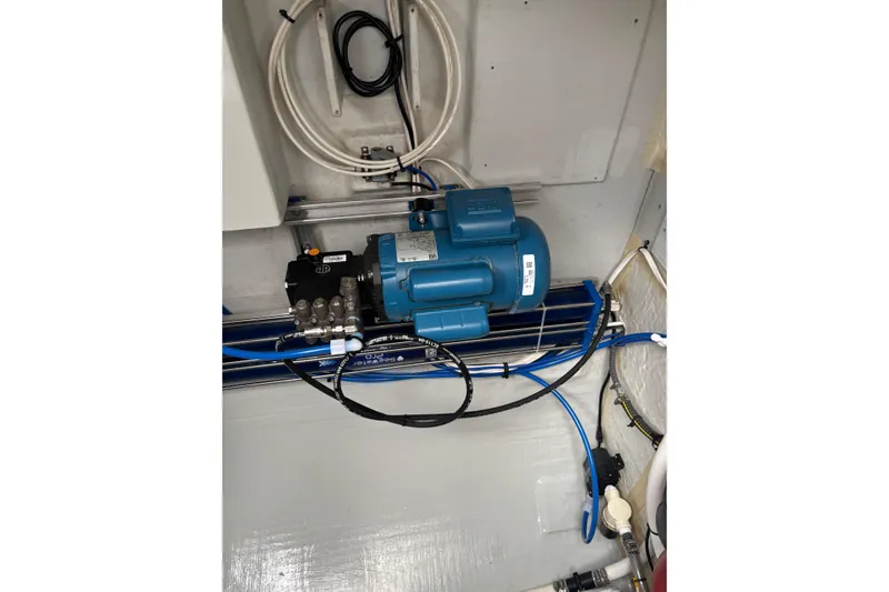 Slide: The Image of Engine room of 2022 Seawind 1600 yacht with blue machinery and cables. - 37