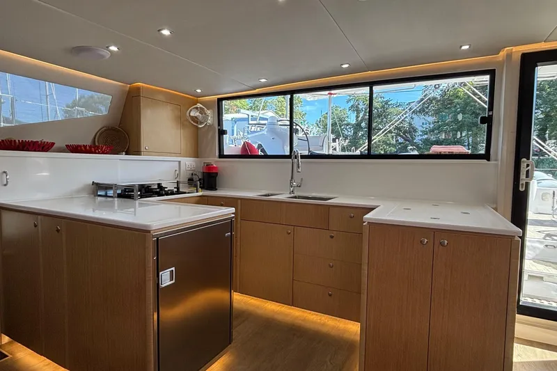 Slide: The Image of Modern kitchen interior of 2022 Seawind 1600 yacht with sleek design and ample natural light. - 9