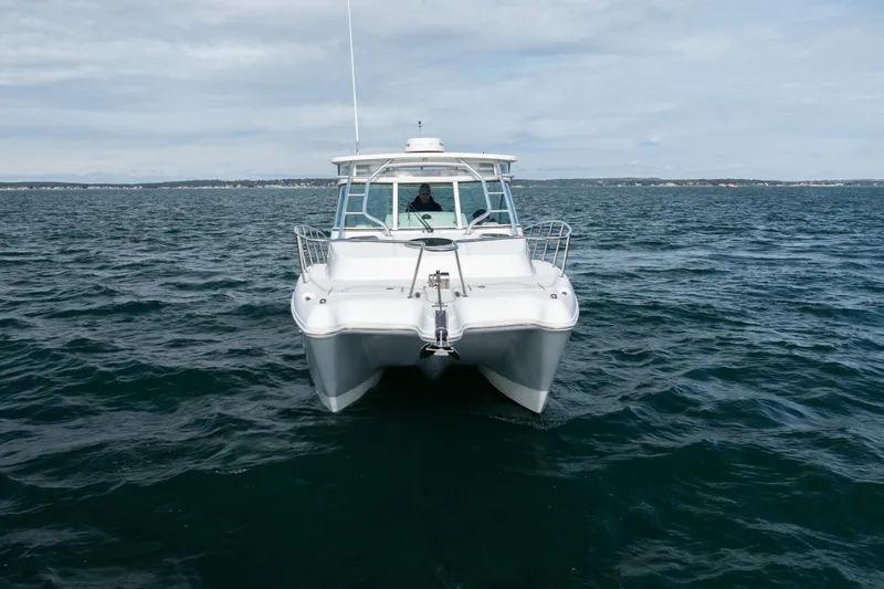 Slide: The Image of 2017 World Cat 320 EC boat on open water, front view. - 10