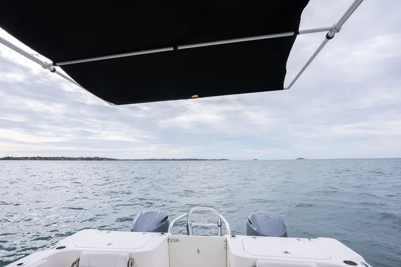 Slide: The Image of 2017 World Cat 320 EC boat on open water under cloudy sky. - 14