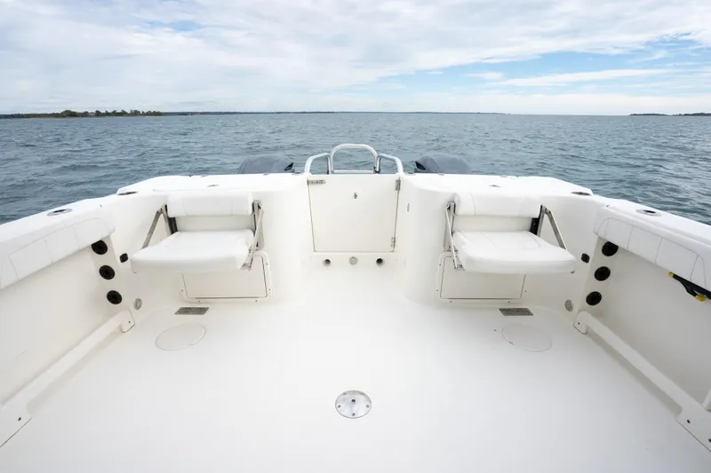Slide: The Image of 2017 World Cat 320 EC boat deck with seating, overlooking calm ocean waters. - 15