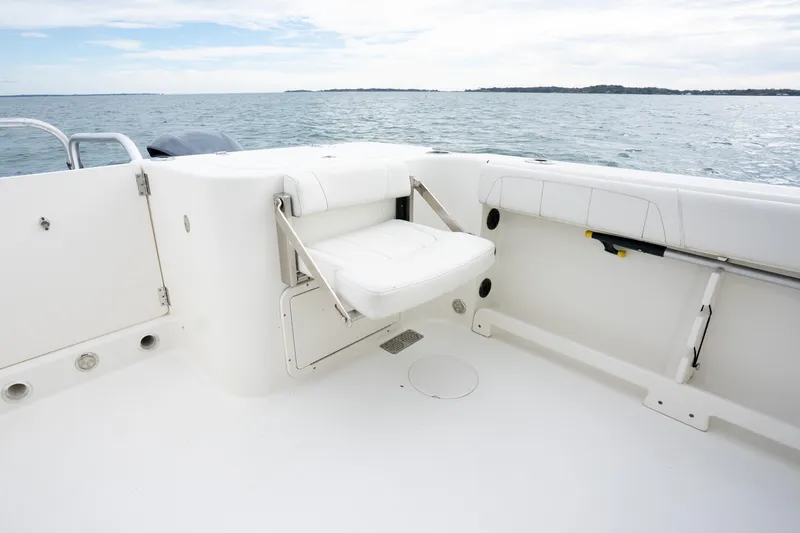 Slide: The Image of 2017 World Cat 320 EC boat interior with foldable seat and ocean view. - 16