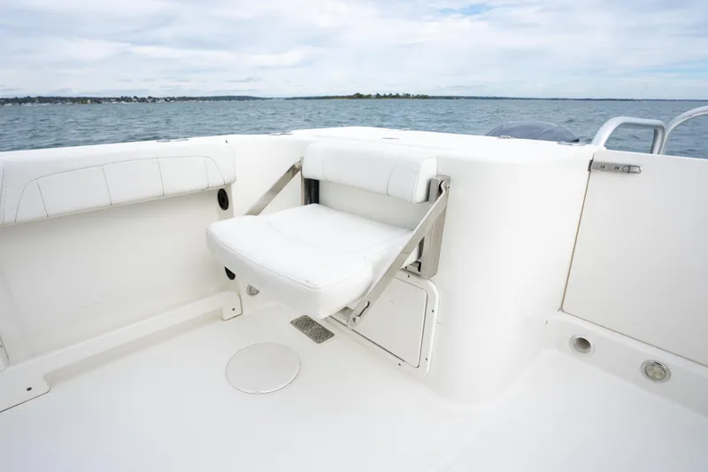 Slide: The Image of 2017 World Cat 320 EC boat interior with white seating and ocean view. - 17
