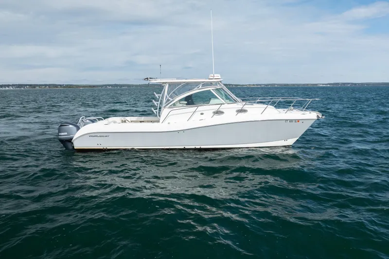 Slide: The Image of 2017 World Cat 320 EC boat on open water, side view. - 2