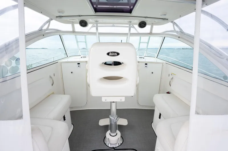 Slide: The Image of Interior of 2017 World Cat 320 EC boat with white seating and helm. - 20