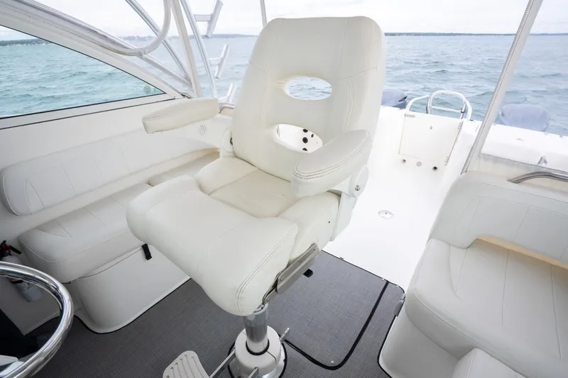 Slide: The Image of Luxury seating on 2017 World Cat 320 EC boat, featuring white leather captain's chair. - 21