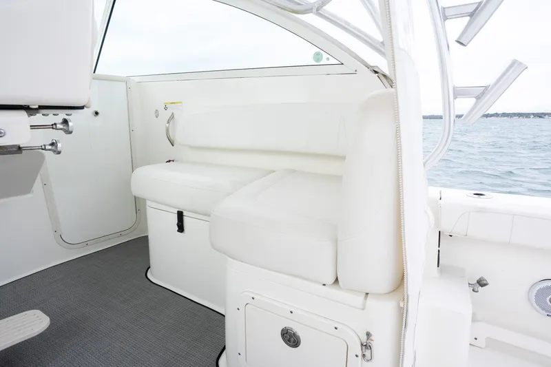 Slide: The Image of 2017 World Cat 320 EC boat interior with white seating and ocean view. - 23