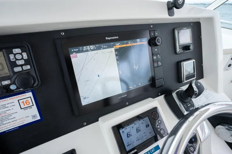 Slide: The Image of Control panel of 2017 World Cat 320 EC with navigation and communication systems. - 26