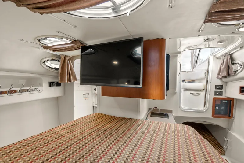 Slide: The Image of 2017 World Cat 320 EC cabin interior with TV, bed, and portholes. - 29