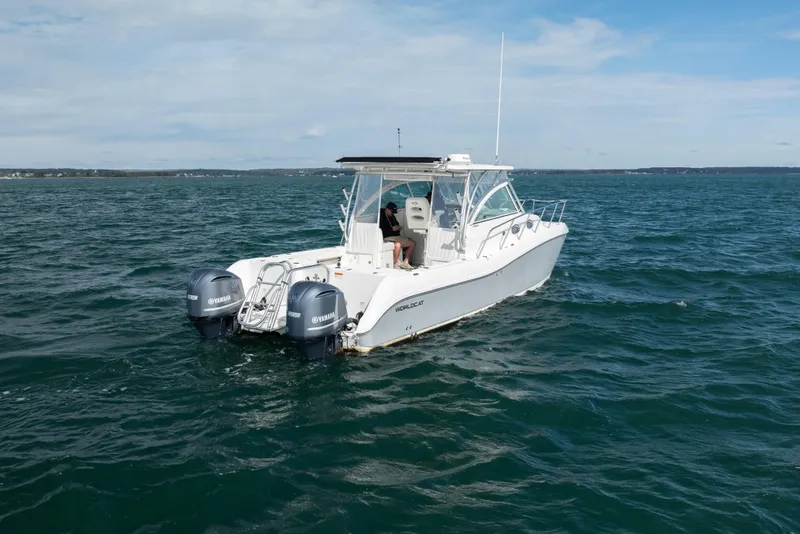 Slide: The Image of 2017 World Cat 320 EC boat with dual Yamaha engines on open water. - 4