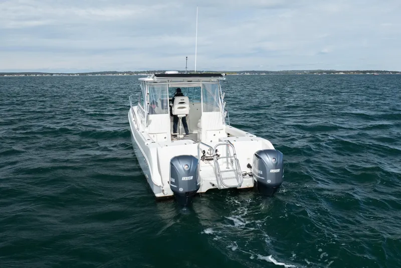 Slide: The Image of 2017 World Cat 320 EC boat on open water, featuring dual Yamaha engines. - 5