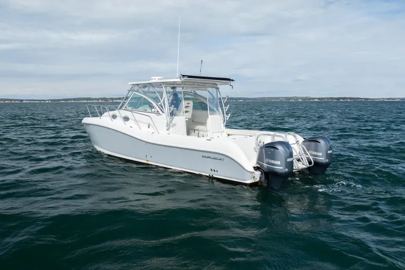 Slide: The Image of 2017 World Cat 320 EC boat on open water with twin Yamaha engines. - 6