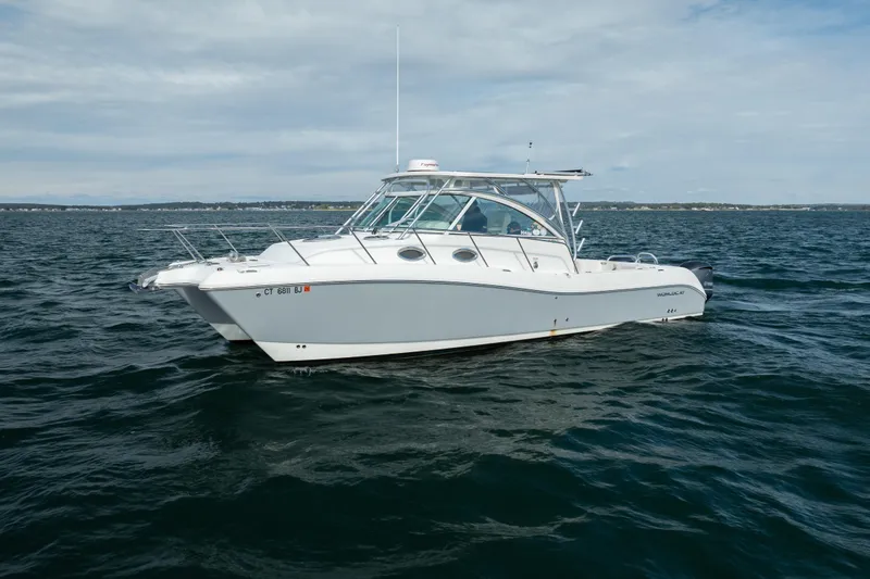 Slide: The Image of 2017 World Cat 320 EC boat on open water under cloudy sky. - 8