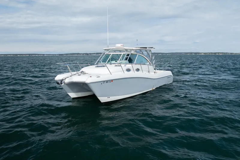 Slide: The Image of 2017 World Cat 320 EC boat on open water under cloudy sky. - 9