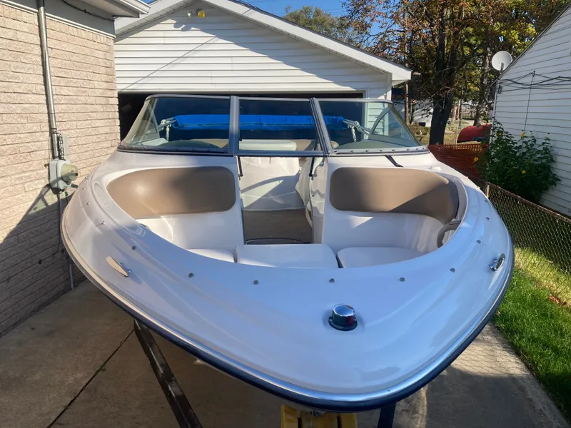 Slide: The Image of 2008 Four Winns 180 Horizon boat parked in driveway, showcasing sleek design and spacious seating. - 1