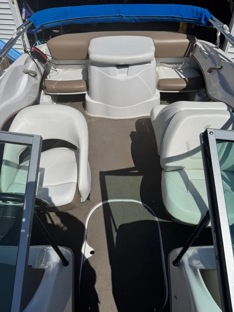 Slide: The Image of 2008 Four Winns 180 Horizon boat interior with white and brown seating. - 10
