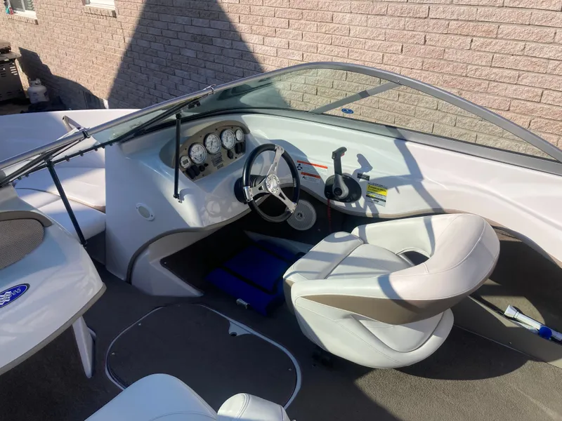 Slide: The Image of 2008 Four Winns 180 Horizon boat interior with steering wheel and dashboard controls. - 11