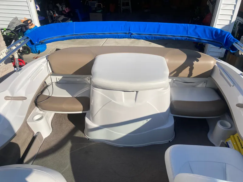 Slide: The Image of 2008 Four Winns 180 Horizon boat interior with beige and white seating, blue canopy. - 14