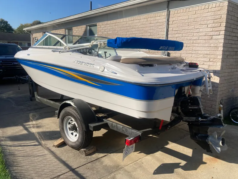 Slide: The Image of 2008 Four Winns 180 Horizon boat on trailer, white with blue and yellow accents. - 2