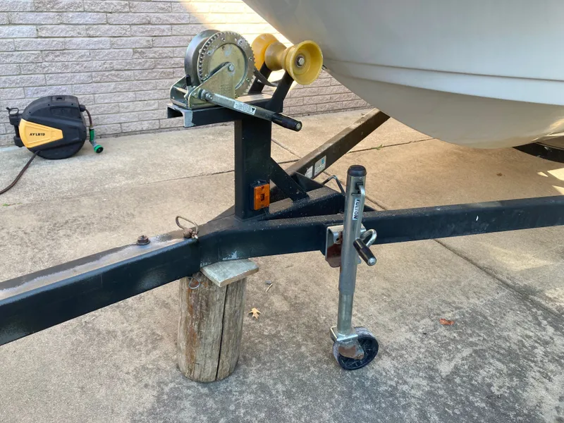 Slide: The Image of Trailer hitch and winch of a 2008 Four Winns 180 Horizon boat on concrete. - 23