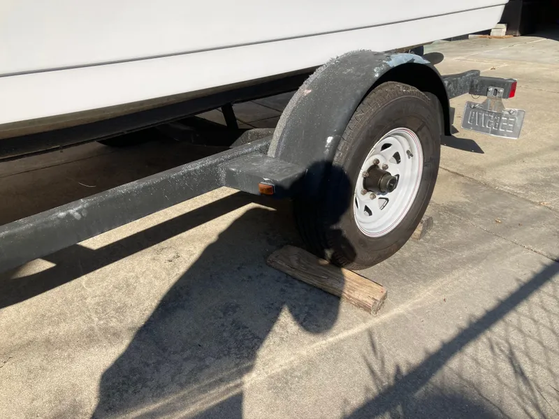 Slide: The Image of Trailer wheel of 2008 Four Winns 180 Horizon boat on wooden blocks. - 24