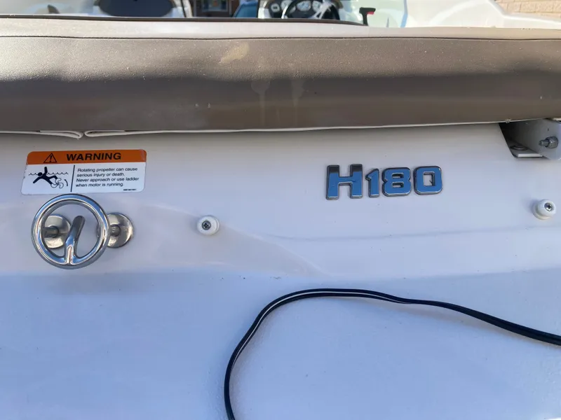 Slide: The Image of 2008 Four Winns 180 Horizon boat stern with warning label and H180 emblem. - 27