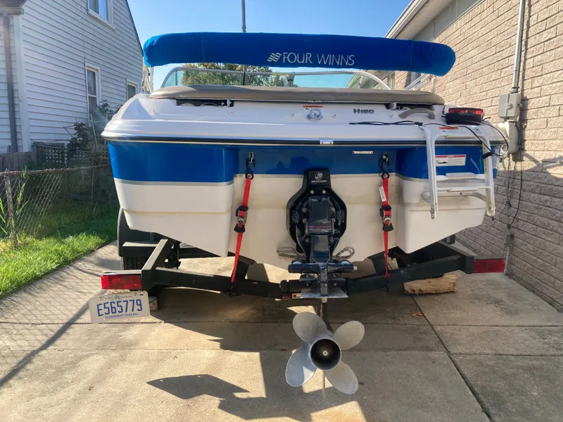 Slide: The Image of 2008 Four Winns 180 Horizon boat on trailer, rear view with propeller and ladder. - 3
