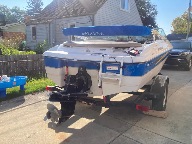 Slide: The Image of 2008 Four Winns 180 Horizon boat on trailer in driveway, sunny day. - 5