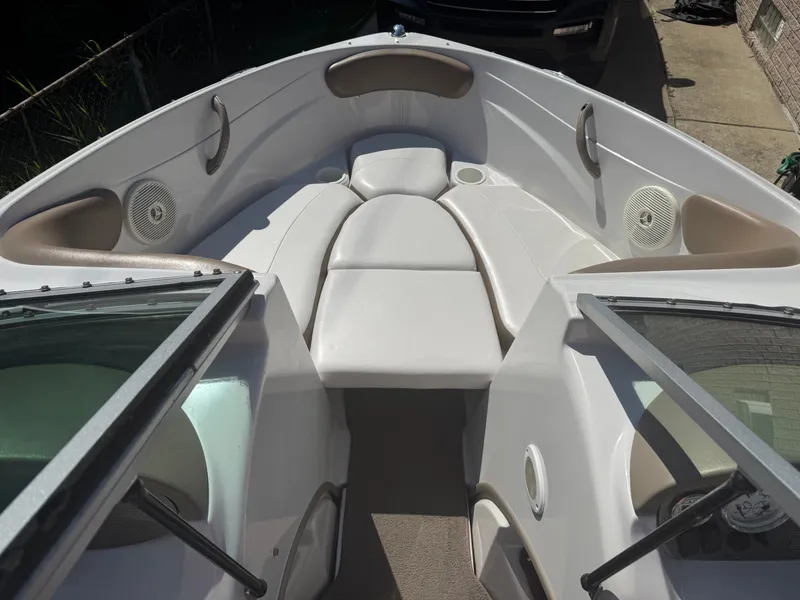 Slide: The Image of 2008 Four Winns 180 Horizon boat interior with white seating and speakers. - 6