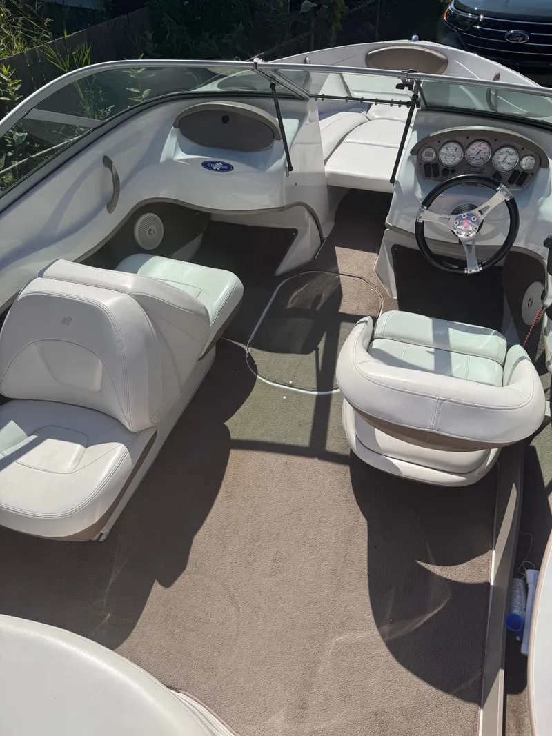 Slide: The Image of 2008 Four Winns 180 Horizon boat interior with white seating and dashboard. - 9