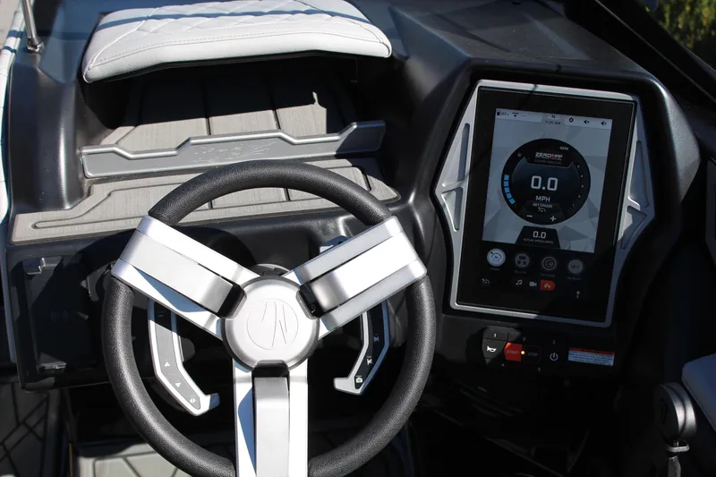 Slide: The Image of 2023 Tigé 24RZX boat dashboard with steering wheel and digital display. - 14