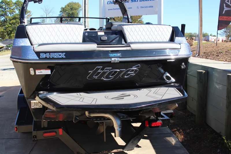 Slide: The Image of 2023 Tigé 24RZX boat rear view with sleek design and seating. - 4