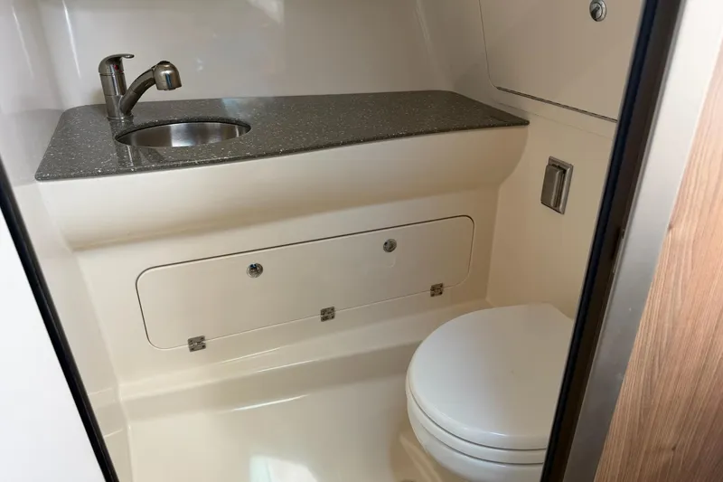 Slide: The Image of 2015 Boston Whaler 315 Conquest bathroom with sink and toilet. - 14