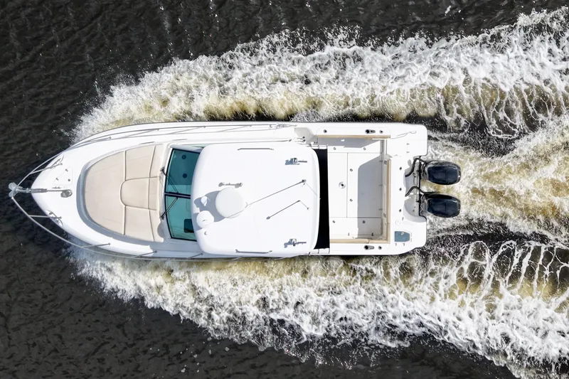 Slide: The Image of Overhead view of 2015 Boston Whaler 315 Conquest boat cruising on water. - 18